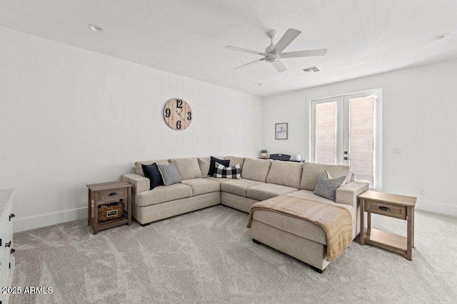 living room featuring light carpet, french doors, and ceiling fan