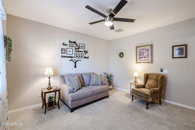 living room with ceiling fan and light colored carpet