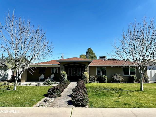 ranch-style home featuring a front yard