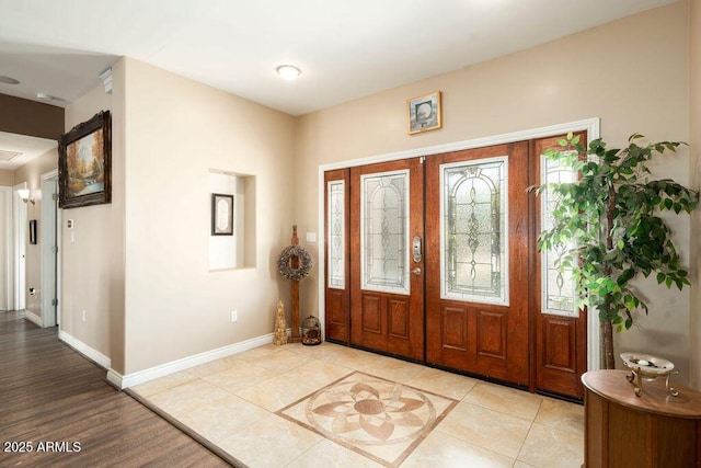 tiled entrance foyer featuring french doors