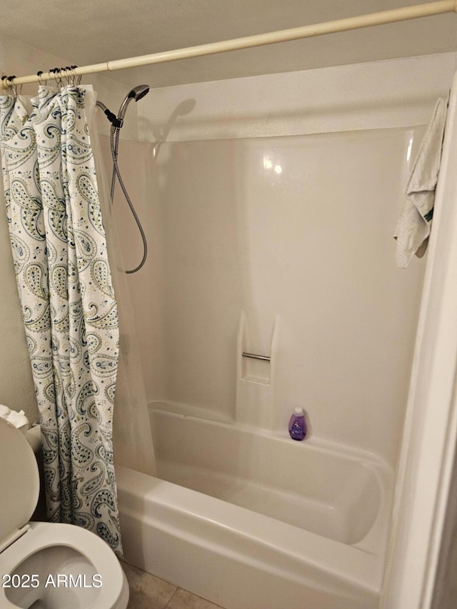 bathroom with toilet, shower / bath combination with curtain, and tile patterned flooring