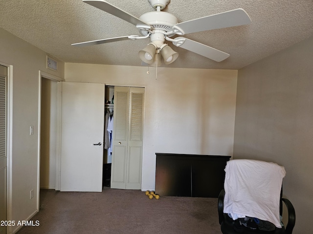 unfurnished bedroom featuring carpet floors, a ceiling fan, a textured ceiling, and visible vents