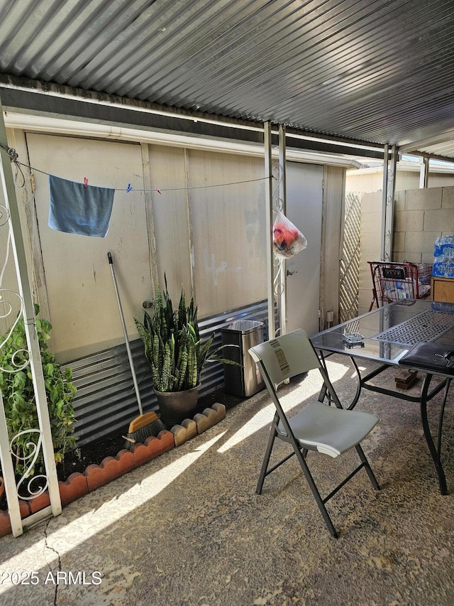 view of patio with fence and outdoor dining space