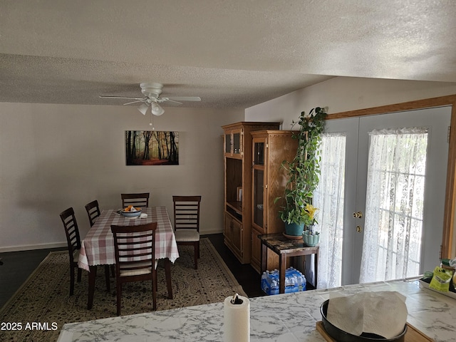dining room with baseboards, a textured ceiling, and ceiling fan