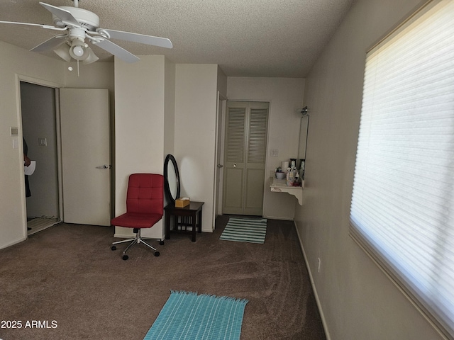 sitting room featuring carpet floors, a ceiling fan, a textured ceiling, and a healthy amount of sunlight