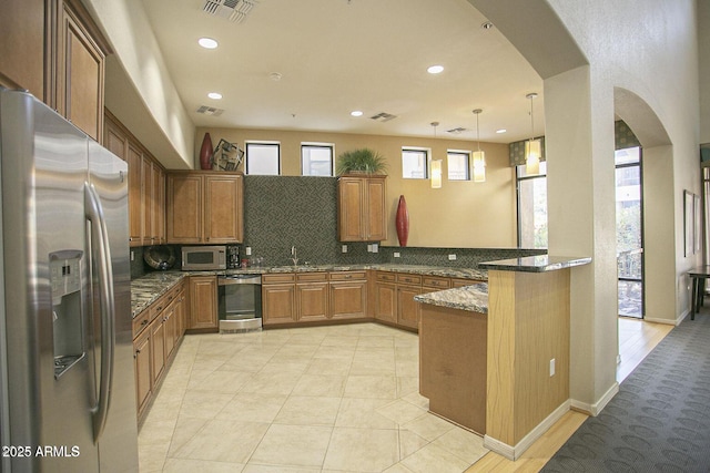 7601 E Indian Bend Rd Unit 1040, Scottsdale, AZ 85250 - kitchen featuring stainless steel fridge, arched walkways, dishwashing machine, a peninsula, and tasteful backsplash