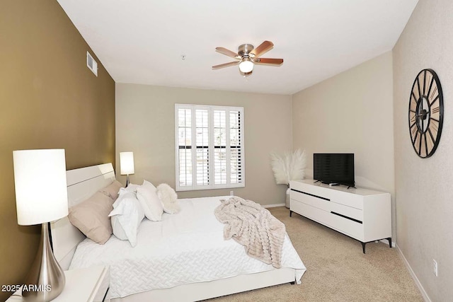 7601 E Indian Bend Rd Unit 1040, Scottsdale, AZ 85250 - bedroom with light carpet, baseboards, and a ceiling fan