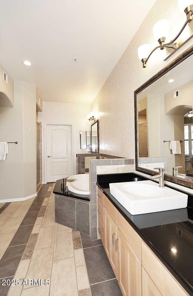 7601 E Indian Bend Rd Unit 1040, Scottsdale, AZ 85250 - bathroom with a bath, vanity, and recessed lighting