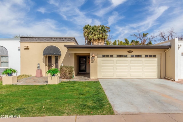 view of front of house featuring a garage and a front lawn