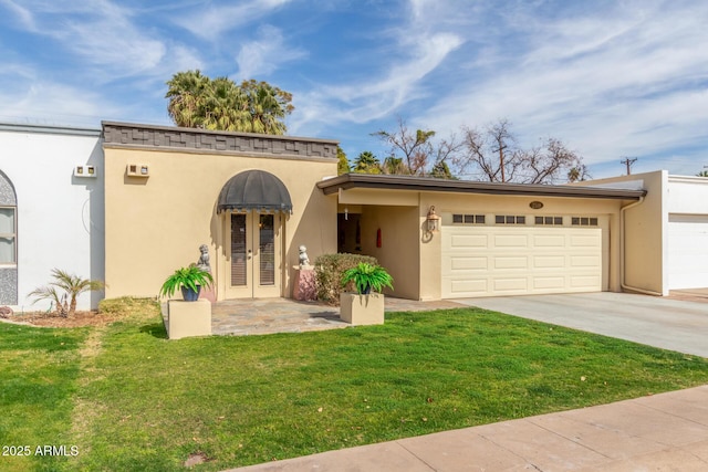 view of front of property with a garage and a front lawn