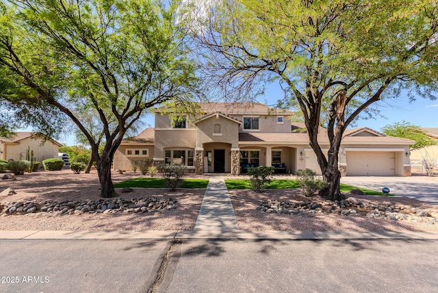9998 W Prospector Dr, Queen Creek, AZ 85144 - mediterranean / spanish house with stucco siding, stone siding, an attached garage, and driveway