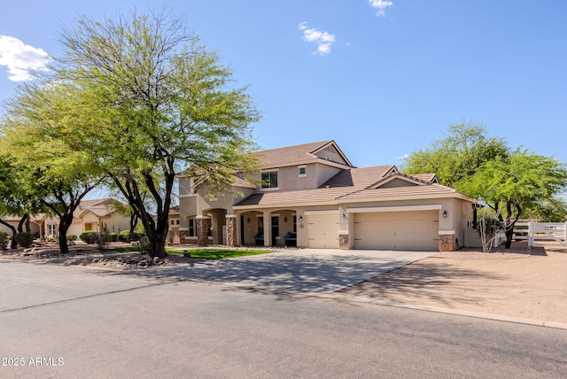 9998 W Prospector Dr, Queen Creek, AZ 85144 - view of front facade with fence, stone siding, stucco siding, and a garage