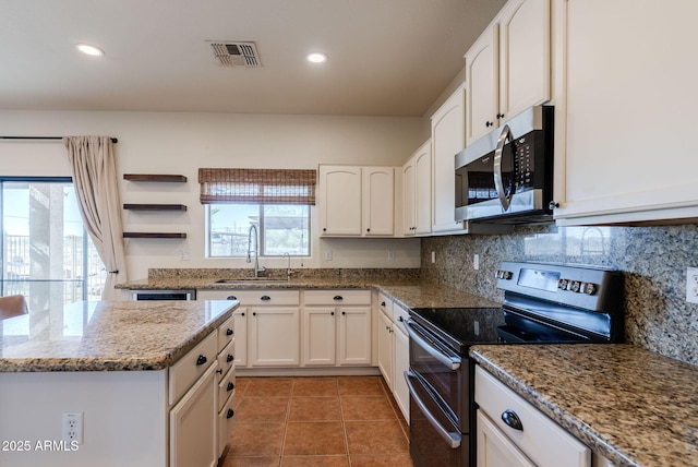 9998 W Prospector Dr, Queen Creek, AZ 85144 - kitchen featuring stainless steel appliances, a sink, white cabinetry, light stone counters, and backsplash