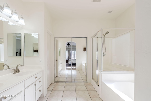 9998 W Prospector Dr, Queen Creek, AZ 85144 - ensuite bathroom with a shower stall, double vanity, a garden tub, and tile patterned floors