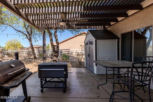 9998 W Prospector Dr, Queen Creek, AZ 85144 - view of patio featuring a pergola, fence, ceiling fan, outdoor dining space, and an outbuilding
