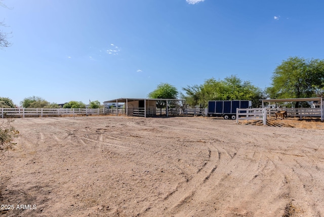 9998 W Prospector Dr, Queen Creek, AZ 85144 - view of yard with an exterior structure, an outdoor riding arena, an outdoor structure, and a view of countryside