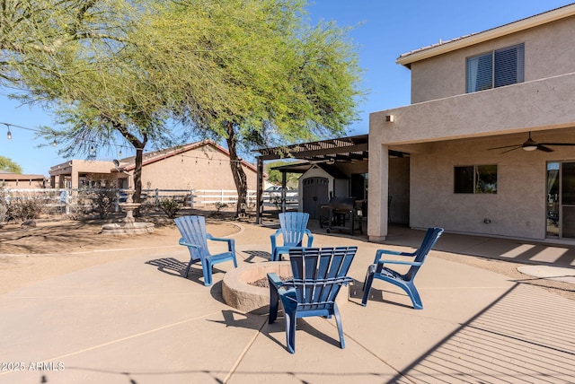 9998 W Prospector Dr, Queen Creek, AZ 85144 - view of patio featuring an outdoor fire pit, a ceiling fan, fence, a shed, and an outdoor structure