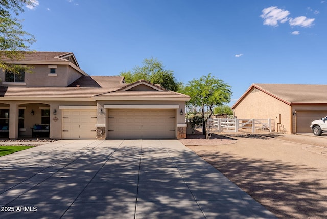 9998 W Prospector Dr, Queen Creek, AZ 85144 - view of front facade featuring stucco siding, fence, a tiled roof, a garage, and driveway