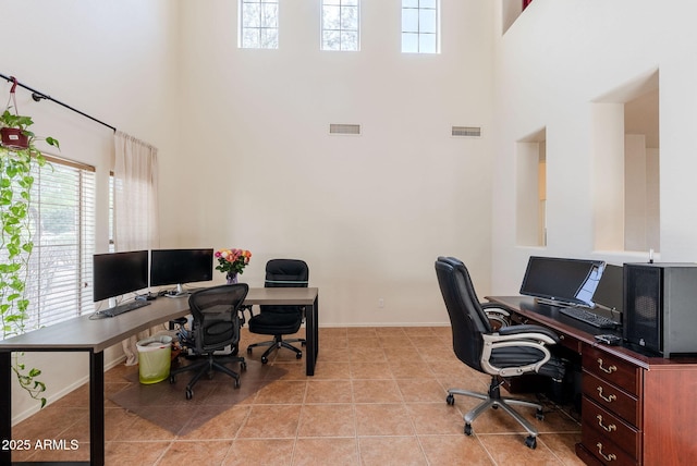 9998 W Prospector Dr, Queen Creek, AZ 85144 - office featuring a towering ceiling, healthy amount of natural light, tile patterned floors, and baseboards