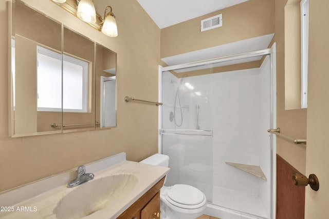 bathroom featuring toilet, an enclosed shower, and vanity