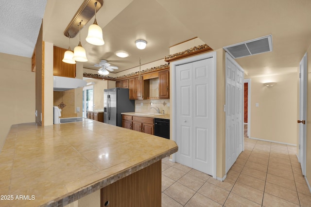 kitchen featuring ceiling fan, sink, decorative light fixtures, dishwasher, and stainless steel fridge with ice dispenser