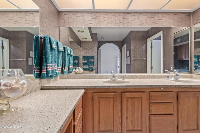 full bath featuring double vanity and a sink