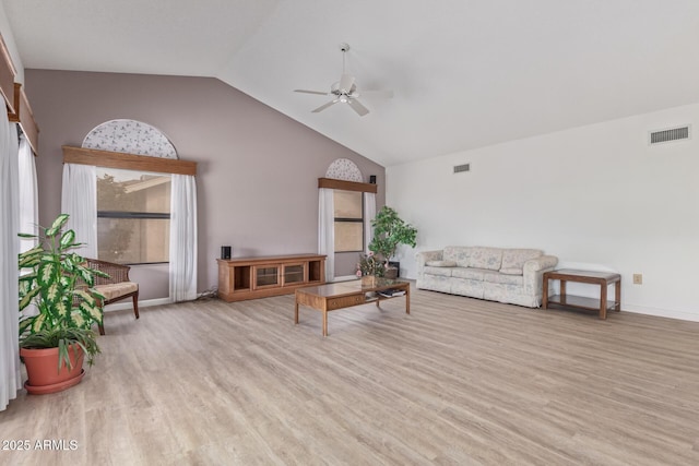 living room featuring vaulted ceiling, wood finished floors, visible vents, and ceiling fan