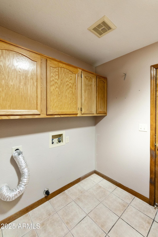 laundry room with visible vents, baseboards, light tile patterned floors, hookup for a washing machine, and cabinet space