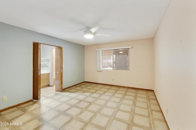 empty room with light floors, baseboards, and a ceiling fan