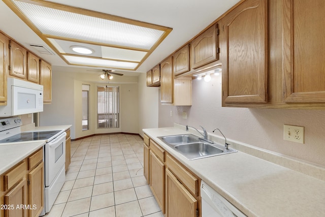 kitchen with visible vents, a sink, white appliances, light countertops, and light tile patterned floors