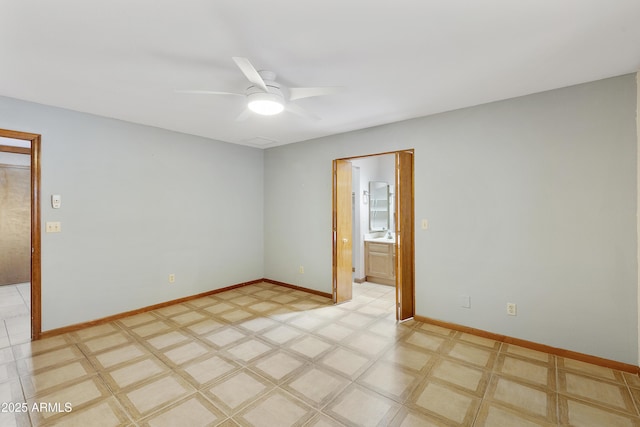unfurnished room with light floors, baseboards, and a ceiling fan