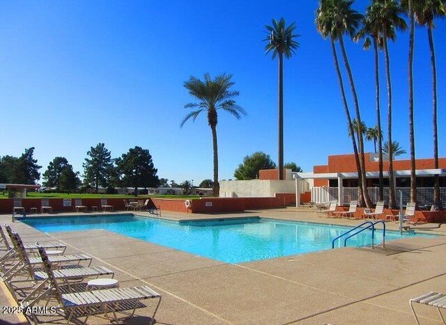 pool featuring a patio and fence
