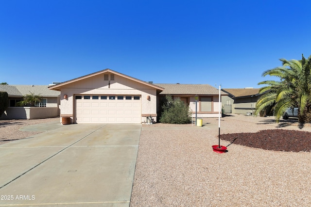 ranch-style house featuring a garage and driveway