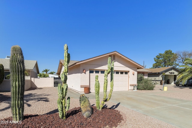ranch-style home with concrete driveway, a garage, and fence
