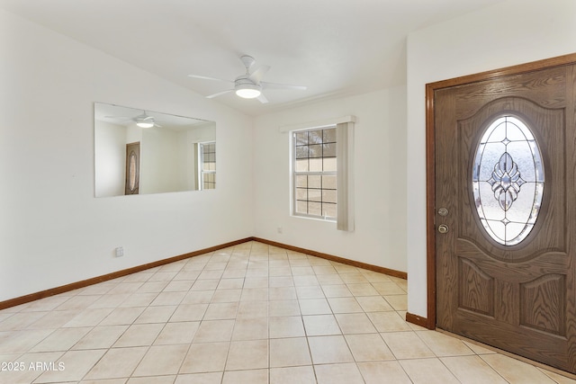 entryway featuring light tile patterned floors, baseboards, lofted ceiling, and ceiling fan