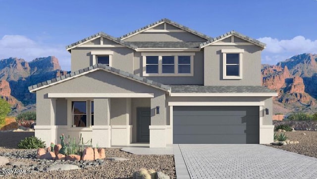 view of front facade featuring a garage and a mountain view