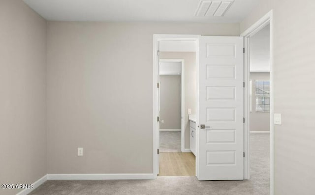 unfurnished bedroom featuring light carpet