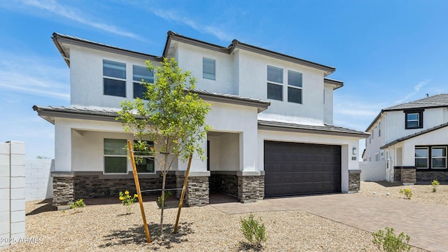 2316 W Moody Trl, Phoenix, AZ 85041 - view of front of house with stone siding, an attached garage, and stucco siding