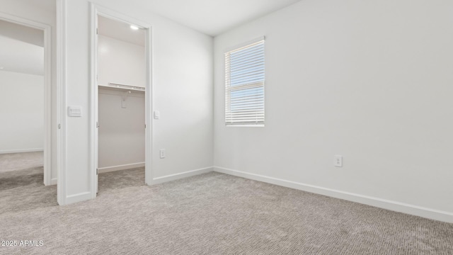 2316 W Moody Trl, Phoenix, AZ 85041 - unfurnished bedroom with light carpet, a spacious closet, baseboards, and a closet