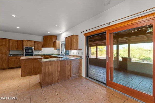 1503 N Thrasher Ln, Wickenburg, AZ 85390 - kitchen with brown cabinets, healthy amount of natural light, light tile patterned floors, and recessed lighting