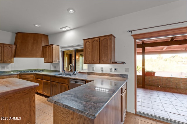 1503 N Thrasher Ln, Wickenburg, AZ 85390 - kitchen featuring light tile patterned floors, appliances with stainless steel finishes, brown cabinetry, a peninsula, and recessed lighting