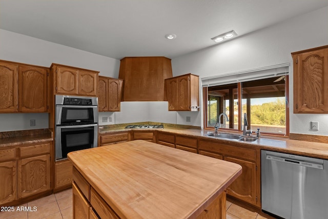 1503 N Thrasher Ln, Wickenburg, AZ 85390 - kitchen featuring appliances with stainless steel finishes, light tile patterned flooring, and brown cabinetry