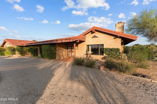 1503 N Thrasher Ln, Wickenburg, AZ 85390 - view of front of property with a chimney, brick siding, and a tiled roof