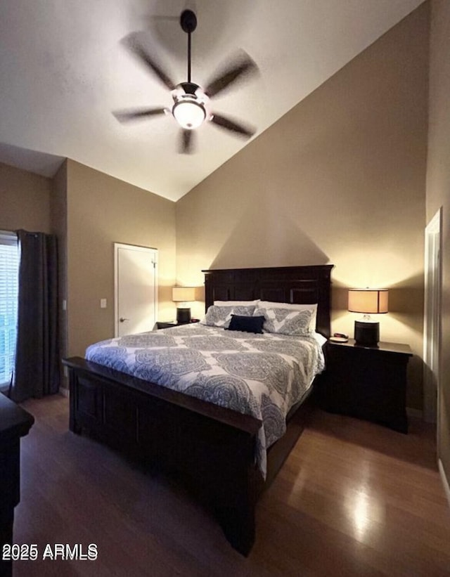 bedroom featuring lofted ceiling and dark wood finished floors