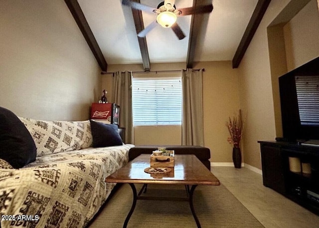 living area with lofted ceiling with beams, ceiling fan, and baseboards