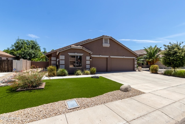 view of front of property with a garage and a front lawn