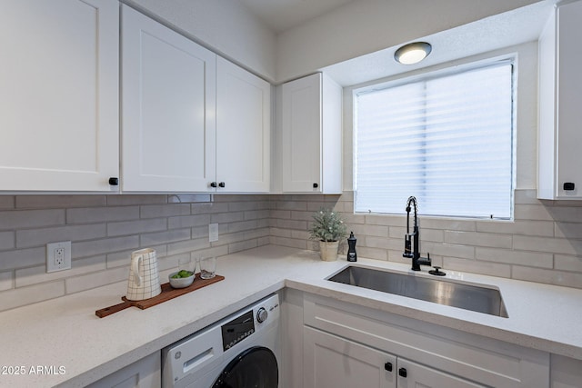 4740 E Portland St, Phoenix, AZ 85008 - kitchen with white cabinets, decorative backsplash, a sink, and washer / clothes dryer