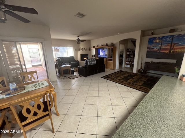 tiled living room featuring ceiling fan