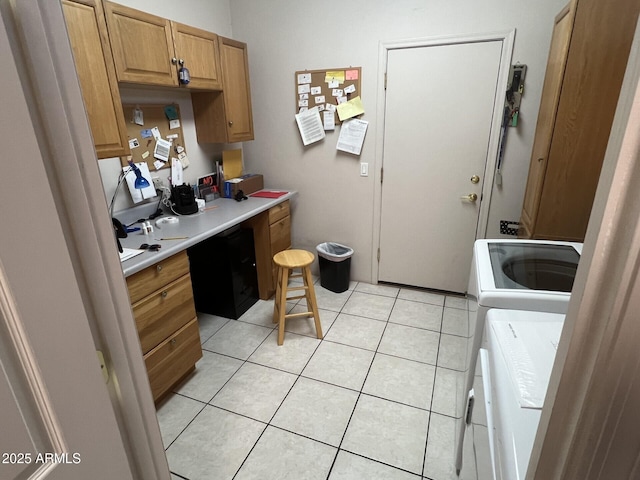 kitchen with washer and clothes dryer and light tile patterned floors