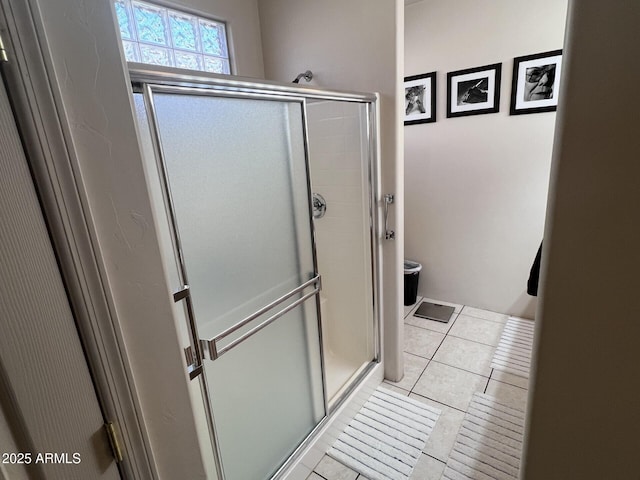 bathroom featuring an enclosed shower and tile patterned floors